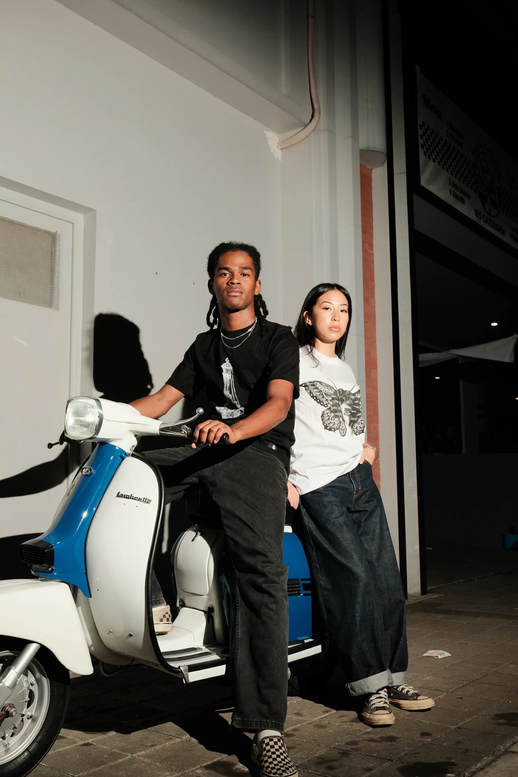 Two TOHO models with a blue scooter beside them.