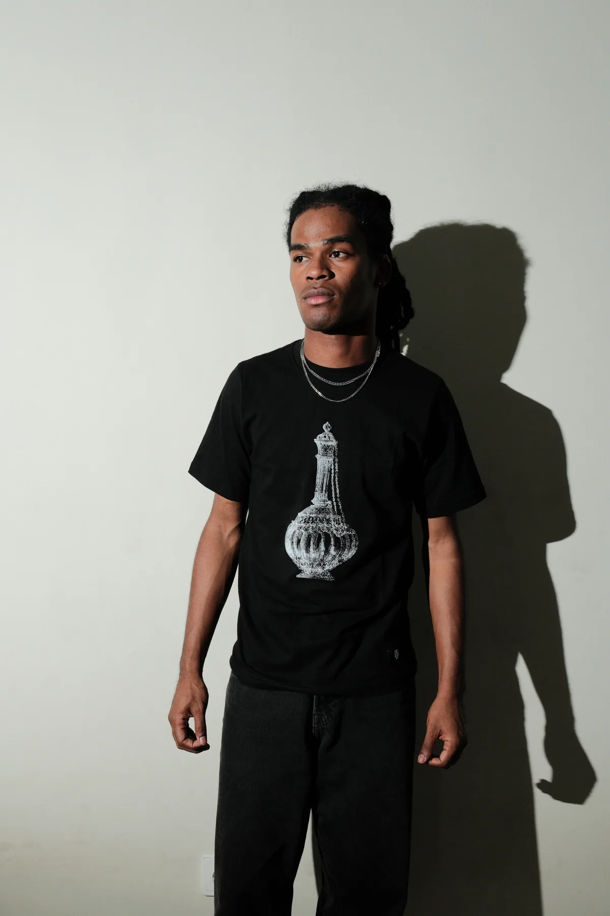 Model wearing the black Vessel graphic T-shirt.